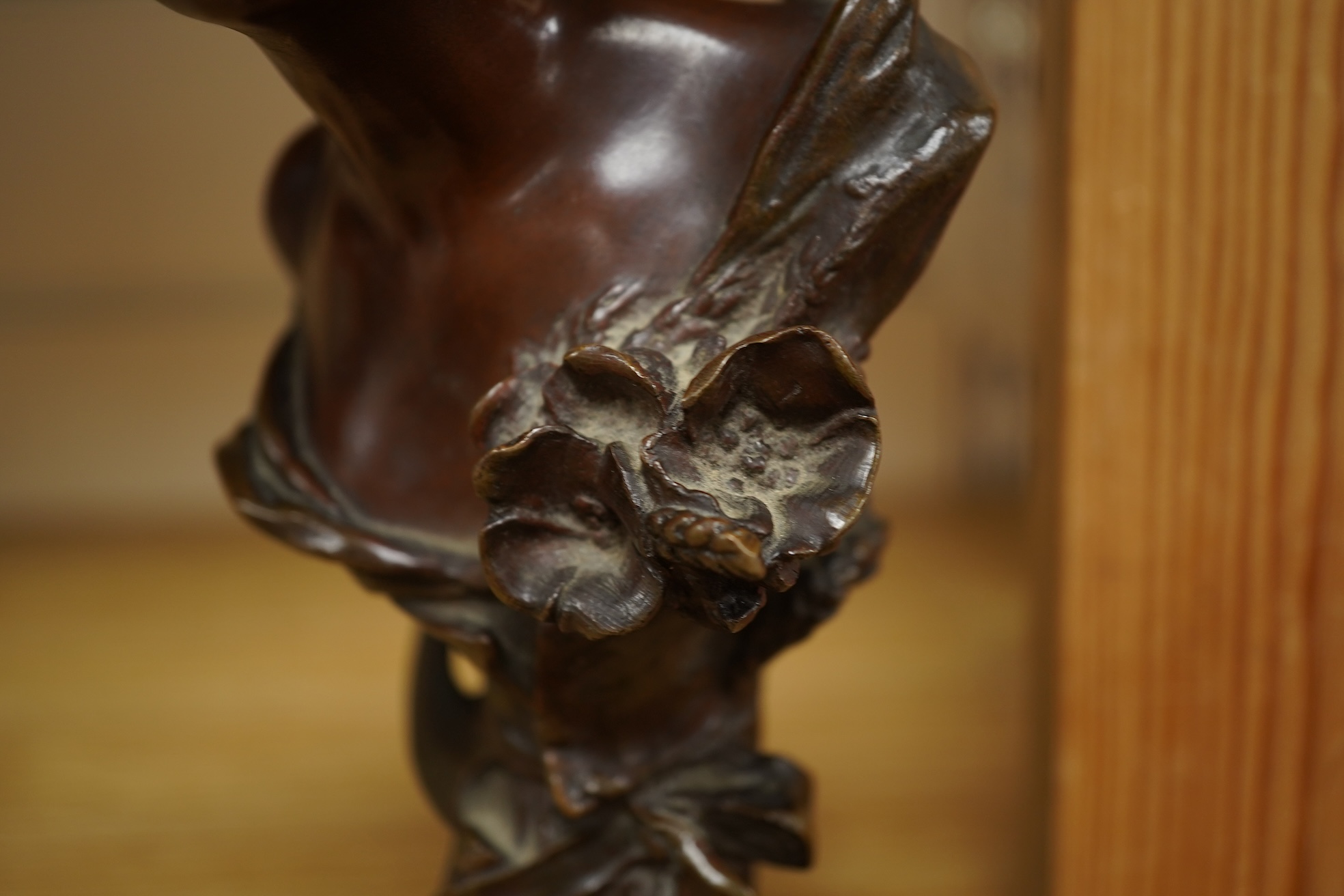 A late 19th century bronze bust of a lady in a hat with floral decoration , mounted on marble, signed, 21.5cm high.